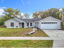 Charming single-story home featuring an attached two-car garage, well-maintained lawn, and neutral-toned exterior at 790 Silhouette Ct, Longwood, FL 32750