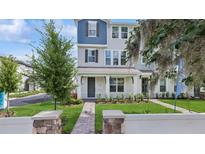 Charming, two-story townhome with a landscaped front yard and welcoming entryway at 2171 E South St # 5, Orlando, FL 32803