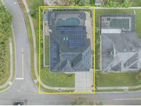 Aerial view of a home with a pool, solar panels, and well-maintained landscaping at 3136 Heartleaf Pl, Winter Park, FL 32792