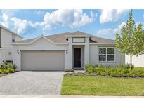 Charming single-story home featuring a well-manicured lawn, brick driveway, and neutral paint scheme at 3106 Windswept, Wildwood, FL 34785