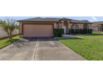 Charming single-story home with a two-car garage and well-maintained lawn at 2686 Maxwell W Ct, Kissimmee, FL 34743