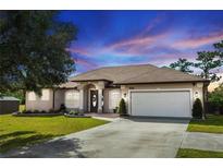 Single-story home with a two-car garage and landscaped lawn at 19808 Seaview St, Orlando, FL 32833