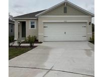 Charming single-story home with a two-car garage and well-maintained landscaping at 3460 Sandalwood Isle Way, Ocoee, FL 34761