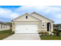 Neutral colored home featuring an attached two car garage and well-maintained landscaping at 3545 Fort Mellon Ln, Sanford, FL 32773