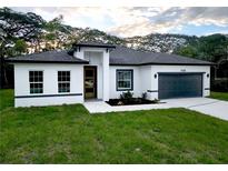 Charming single-story home boasts a well-manicured lawn and a two-car garage at 17126 Sw 42Nd Ter, Ocala, FL 34473