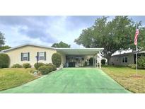 Charming single-story home featuring a covered carport and well-maintained lawn at 6604 Scenic Point Se Dr, Winter Haven, FL 33884