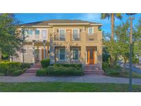 Beautiful two-story townhouse with a well-maintained front yard and charming architectural details at 14046 Walcott Ave, Orlando, FL 32827