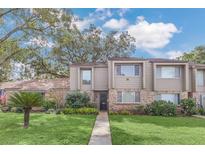 Two-story townhome with brick and siding exterior, landscaped lawn, and walkway at 456 Oak Haven Dr # Bldg 35, Altamonte Springs, FL 32701