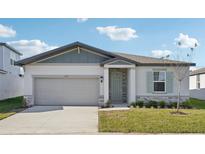One-story home with gray siding, light green door, and landscaped lawn at 2149 Rosewood Dr, Bartow, FL 33830