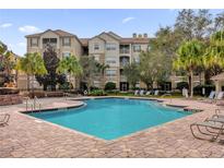 Community pool with lounge chairs, offering a relaxing outdoor space at 3326 Robert Trent Jones Dr # 401, Orlando, FL 32835