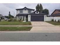 Charming two-story home with a neatly manicured front yard and a two car garage at 370 Chicago Woods Cir, Orlando, FL 32824
