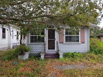 Charming home featuring light blue siding and a cozy entrance, framed by lush greenery at 1105 S Locust Ave, Sanford, FL 32771