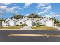 Three-unit building showcasing a charming exterior, with two-car garages and well-maintained landscaping at 2402 Sw 20Th Ter, Ocala, FL 34471