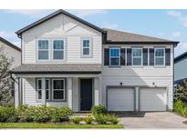 Charming two-story home with a two-car garage, black shutters, and beautiful landscaping at 11218 Pixie Mandarin Ct, Winter Garden, FL 34787