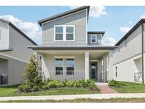 Charming two-story home with modern design, covered porch, and manicured landscaping for curb appeal at 5015 Railroad Vine Aly, Winter Garden, FL 34787