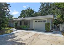 Updated home exterior with a gray color scheme, landscaped yard, and driveway at 924 Beard Ave, Winter Park, FL 32789