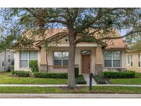 Craftsman style home with a brown door and stone accents at 12953 Runswick Ave, Windermere, FL 34786