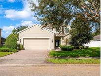 Two-story house with attached garage and landscaped lawn at 1601 Blue Grass Blvd, Deland, FL 32724