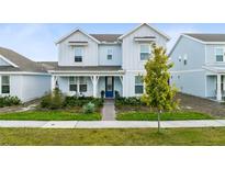 Two-story light blue house with a front porch and landscaped yard at 6522 Rover Way, St Cloud, FL 34771
