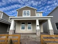 Two-story house with gray siding, covered porch, and brick columns at 5312 Center Lake Ranch Blvd, Saint Cloud, FL 34771