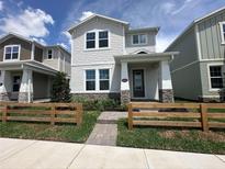 Charming two-story home featuring stone accents, manicured landscaping, and a welcoming front porch at 5318 Center Lake Ranch Blvd, St Cloud, FL 34771