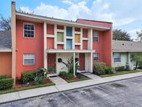 Charming multi-Gathering home featuring vibrant coral exteriors, colorful accents, and well-maintained landscaping at 4786 Tangerine Ave # 4786, Winter Park, FL 32792