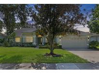 One-story house with a two-car garage and well-manicured lawn at 7506 Lindenhurst Dr, Orlando, FL 32836