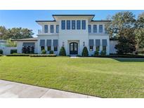 Stunning two-story home with a manicured lawn and a balcony, perfect for enjoying the outdoors at 1948 Rowena Ave, Orlando, FL 32803