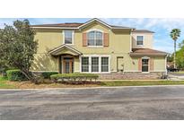 Charming two-story townhome with lush landscaping and a welcoming front entrance at 2129 Victoria Glen Dr, Sanford, FL 32773