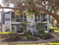 Inviting two-story condo featuring screened porches and beautifully landscaped grounds with mature trees at 606 Northlake Dr # 606, Sanford, FL 32773