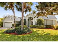 Attractive single-story home with landscaped lawn, palm trees, and a two-car garage at 1657 Carillon Park Dr, Oviedo, FL 32765