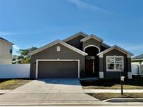 Charming single-story home featuring a two-car garage and inviting front entrance at 326 Highland Meadows Ave, Davenport, FL 33837