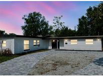 Newly renovated home with gray paver driveway and updated exterior at 1511 E Horatio Ave, Maitland, FL 32751