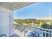 Enjoy the balcony view overlooking a tranquil pond and lush greenery in this charming property at 7383 Universal Blvd # 512, Orlando, FL 32819