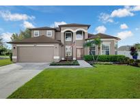 Charming two-story home with a manicured lawn and elegant front entrance, including a fountain at 698 Mt Pleasant Dr, Ocoee, FL 34761