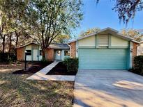Charming single-story home with manicured front yard, brick accents, and a two-car garage at 403 Tranquille Oaks Dr, Ocoee, FL 34761