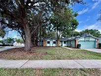 Charming single-story home with a well-maintained lawn and mature trees in a desirable neighborhood at 403 Tranquille Oaks Dr, Ocoee, FL 34761
