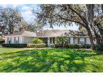 Charming single-story home with well-manicured lawn and mature landscaping at 1845 Farrington Dr, Lakeland, FL 33809