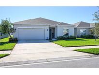 Two-story home with attached garage and well-manicured lawn at 543 Pine Tree Bridge Trail, Saint Cloud, FL 34772