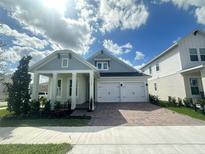 Charming single-story home featuring a two-car garage, covered porch, and well-maintained landscaping at 15086 Summer Harvest St, Winter Garden, FL 34787