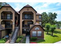 Attractive multi-story condo with balconies, brick accents, and well-maintained landscaping at 375 Lake Ontario Ct # 102, Altamonte Springs, FL 32701