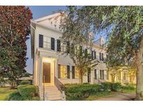 Evening view of charming townhome with classic architecture and landscaping at 2891 Upper Park Rd, Orlando, FL 32814