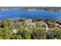 Stunning aerial view of waterfront homes featuring lush landscaping, private pools, and access to a beautiful lake at 2032 Dumas Dr, Deltona, FL 32738