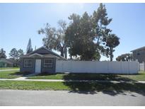Charming single-story home featuring a freshly painted exterior, white picket fence, and well-maintained landscaping at 1600 Roosevelt Ave, Orlando, FL 32804