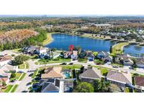 Aerial view of a house near a lake in a quiet residential neighborhood at 10642 Cloudview Dr, Orlando, FL 32825