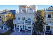 Beautiful two-story home with balconies and a landscaped yard at 7405 Excitement Dr, Kissimmee, FL 34747