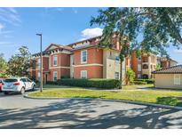 Attractive condominium building with well-maintained landscaping and ample parking at 5578 Metrowest Blvd # 101, Orlando, FL 32811