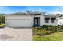 Charming single-story home with a two-car garage and a beautifully landscaped front yard at 1209 Cresswind Blvd, Deland, FL 32724
