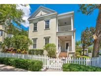 Charming two-story home featuring a white picket fence, front porch, and manicured landscaping at 4685 Anson Ln, Orlando, FL 32814