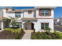 Charming two-story home with a beautifully landscaped front yard and a cozy entrance at 1574 Slice Way, Davenport, FL 33896